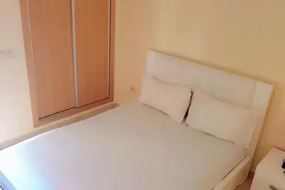 a white bed with two pillows in a room at Séjour spacieux à Marrakech in Marrakech