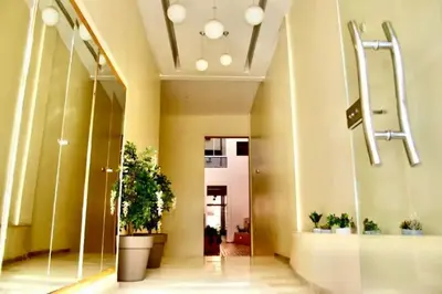 a lobby of a building with potted plants at Séjour spacieux à Marrakech in Marrakech