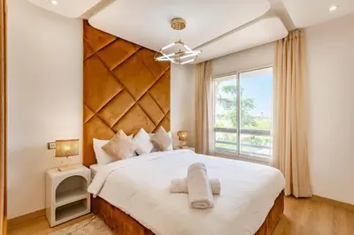 a bedroom with a large white bed with a large window at New! Appt Riad Garden, piscine & wifi & parking in Marrakech