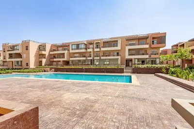 an apartment with a swimming pool in front of a building at New! Appt Riad Garden, piscine & wifi & parking in Marrakech