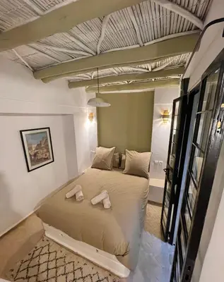 a bedroom with a bed with two towels on it at Riad Dardeco privé centre Medina Marrakech in Marrakech