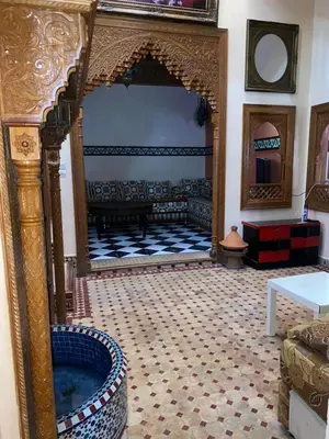 a living room with a large room with a fireplace at Riad Tichka piscine palmeraie in Marrakech