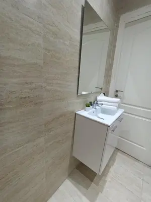 a bathroom with a white sink and a mirror at Palace appart Marrakech - hivernage in Marrakech