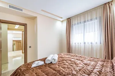 a bedroom with a bed with two towels on it at New! Appt Spacieux et Lumineux à Menara Garden in Marrakech