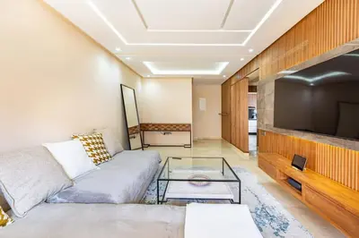 a living room with a couch and a tv at New! Appt Spacieux et Lumineux à Menara Garden in Marrakech