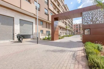 a motorcycle parked in front of a building at New! Appt Spacieux et Lumineux à Menara Garden in Marrakech
