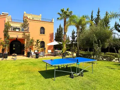 a ping pong table in front of a house at Palais Ona in Marrakech