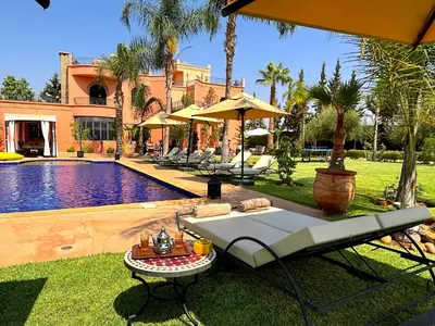 a backyard with a swimming pool and a resort at Palais Ona in Marrakech