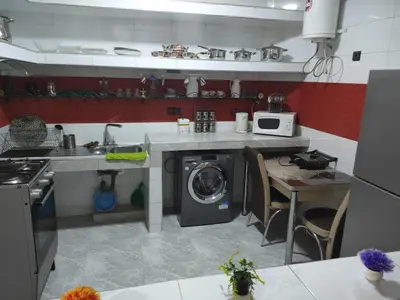 a kitchen with a washing machine and a stove at Appartement de luxe in Marrakech