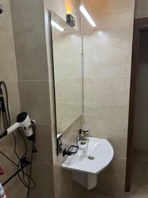 a bathroom with a sink and a mirror at Appartement à Gueliz près de toute commodité in Marrakech