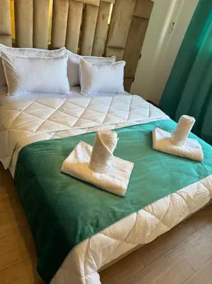 two towels on a bed with hats on it at Appartement à Gueliz près de toute commodité in Marrakech