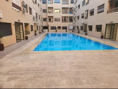 a swimming pool in the middle of a building at Appartement au centre de gueliz in Marrakech