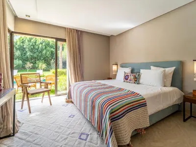 a bedroom with a bed and a large window at Villa Albatros in Marrakech
