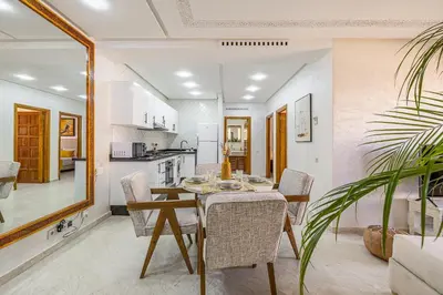 a kitchen and dining room with a table and chairs at Appartement Marrakech - quartier Gueliz in Marrakech