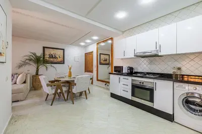 a kitchen with a table and a dining room at Appartement Marrakech - quartier Gueliz in Marrakech