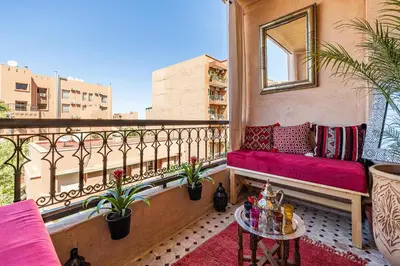 a balcony with a bench and a table at Appartement Marrakech - quartier Gueliz in Marrakech