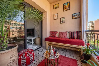a balcony with a red bench on a balcony at Appartement Marrakech - quartier Gueliz in Marrakech