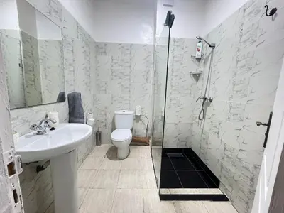 a bathroom with a toilet and a sink and a shower at La rose à côté Carry in Marrakech