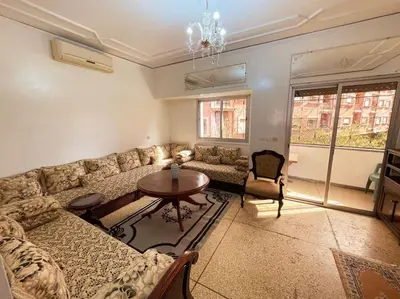 a living room with a couch and a table at appartement au coeur de marrakech proche de tout in Marrakech