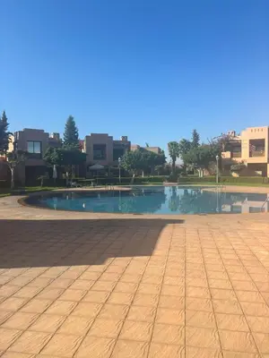 a swimming pool in the middle of a city at Beautiful cozy apartment with pool in Marrakech