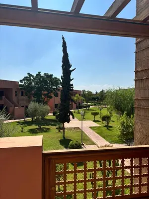 a view from a balcony of a garden at Beautiful cozy apartment with pool in Marrakech