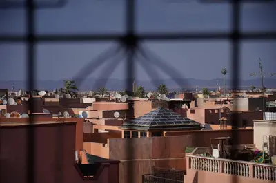 a view of roofs of buildings from a window at Jardin Majorelle Appartement in Marrakech
