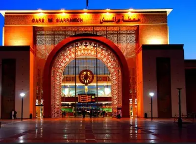 a large building with an arch with a clock on it at Appartement Haut standing in Marrakech