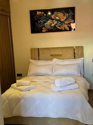 a bedroom with a bed with two towels on it at Appartement Haut standing in Marrakech