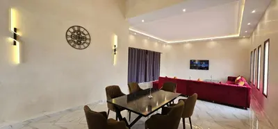 a dining room with a table and a red couch at Villa privée sans vis-vis in Marrakech