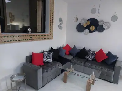 a living room with a couch with red and blue pillows at Marrakech in Marrakech