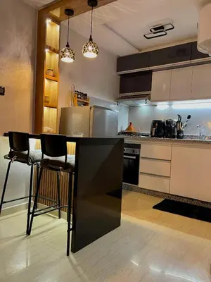 a kitchen with a black counter top in a room at Victorious Suites in Marrakech