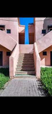 a set of stairs leading up to a building at Très joli appartement à Atlas Golf Resort in Marrakech