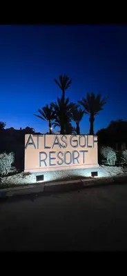 a sign for anolis gold resort with palm trees in the background at Très joli appartement à Atlas Golf Resort in Marrakech