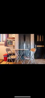 two chairs and a table in a kitchen at Très joli appartement à Atlas Golf Resort in Marrakech