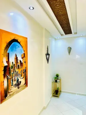 a hallway with a painting on the wall at Appart F3 de luxe à Gueliz - 5 min de la gare - Piscine, WiFi, parking au coeur de Marrakech in Marrakech