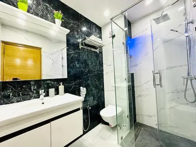 a bathroom with a shower and a sink and a toilet at Appart F3 de luxe à Gueliz - 5 min de la gare - Piscine, WiFi, parking au coeur de Marrakech in Marrakech
