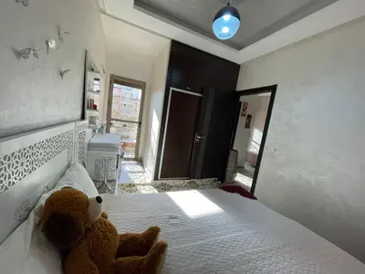 a bedroom with two teddy bears sitting on a bed at Plaza sejour in Marrakech