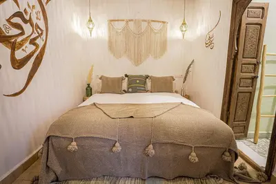 a bedroom with a bed and a mirror at Riad Lamalika in Marrakech