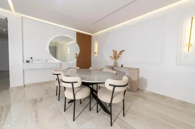 a dining room with a table and chairs and a mirror at Menara Garden duplex 3 suites in Marrakech