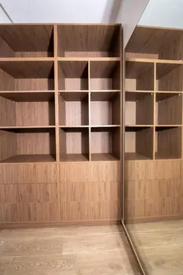 an empty closet with wooden shelves in a room at Menara Garden duplex 3 suites in Marrakech