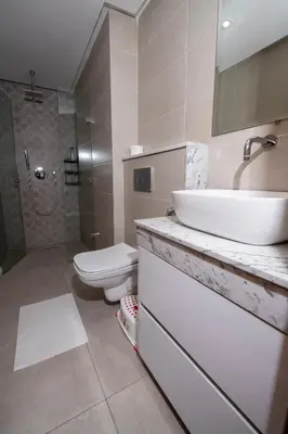 a bathroom with a white sink and a toilet at Menara Garden duplex 3 suites in Marrakech