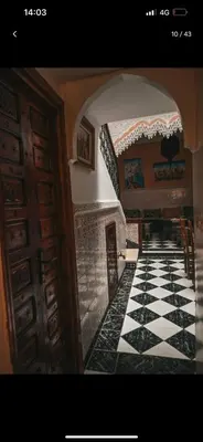 a hallway with a black and white tile floor at 4 bedrooms house & swimming pool in Marrakech