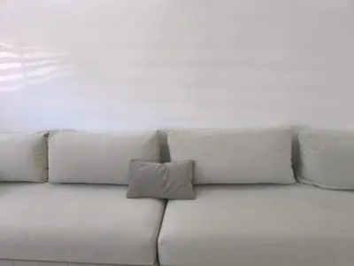 a white couch with four pillows on it at Appartement Piscine à Marrakech in Marrakech