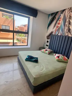a bedroom with a bed with a large window at Villa familiale avec piscine chauffée La Dolce Vita in Marrakech