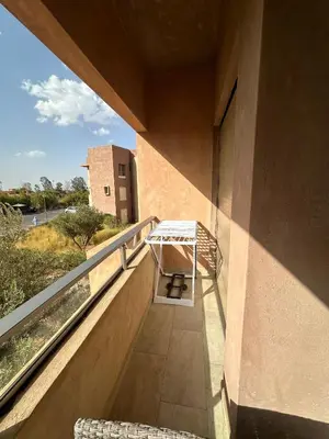 a balcony with a bench on the side of a building at l'écrin de prestigia agate studio in Marrakech