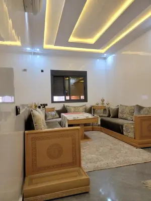 a living room with a couch and a table at Appartement racha in Marrakech