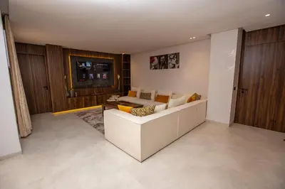 a living room with a couch and a table at Élégance et Prestige à Gueliz Appartement 3 chambres in Marrakech