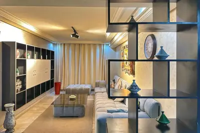 a living room with a couch and a table at Stylish & Comfy Appartment Haven 5 Stars Location Plaza Views in Marrakech