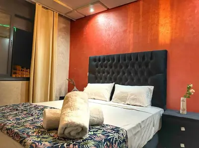 a bedroom with a bed with a stuffed animal on it at Stylish & Comfy Appartment Haven 5 Stars Location Plaza Views in Marrakech