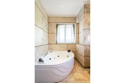 a white tub in a bathroom with a window at Villa palmeraie marrakech in Marrakech